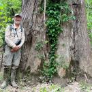 John in front of a tree